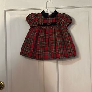 Red plaid dress with rose accent.